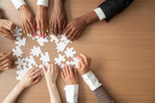 A group of people putting a puzzle together