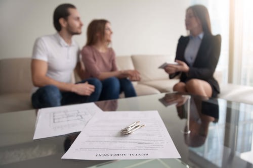 A couple speaking to someone about renting a house